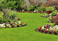 An estate home with a perfectly manicured striped lawn